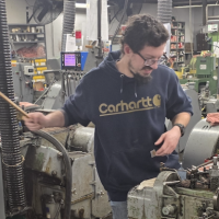 Todd on the shop floor at Crescent, operating a cold-header.